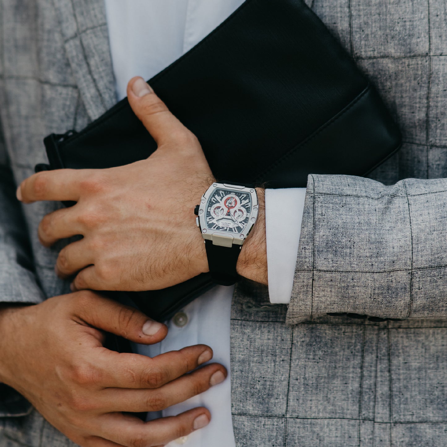 Mateo Moretti Anapo Argento luxury menβs watch with silver case, black strap, and skeleton dial β lifestyle wrist shot with suit