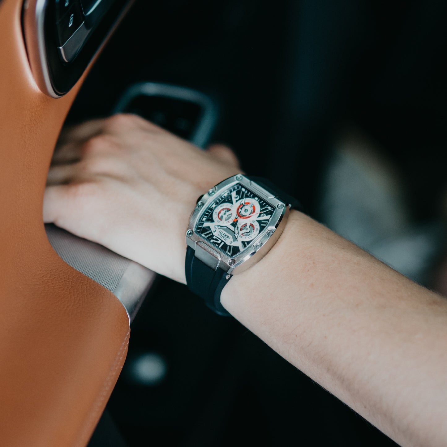 Mateo Moretti Anapo Argento luxury skeleton watch with silver case and black strap β wrist shot while driving