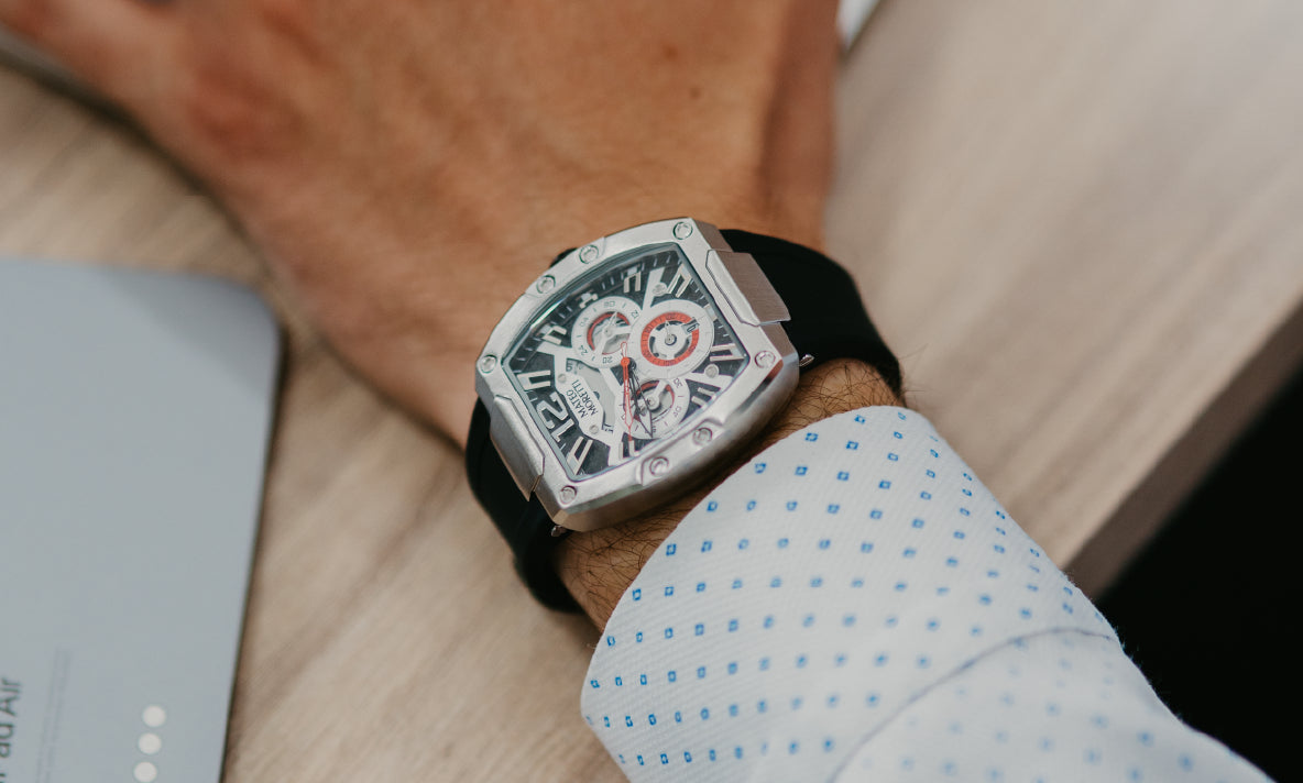 Mateo Moretti tonneau-case skeleton chronograph with black rubber strap on wrist at a desk
