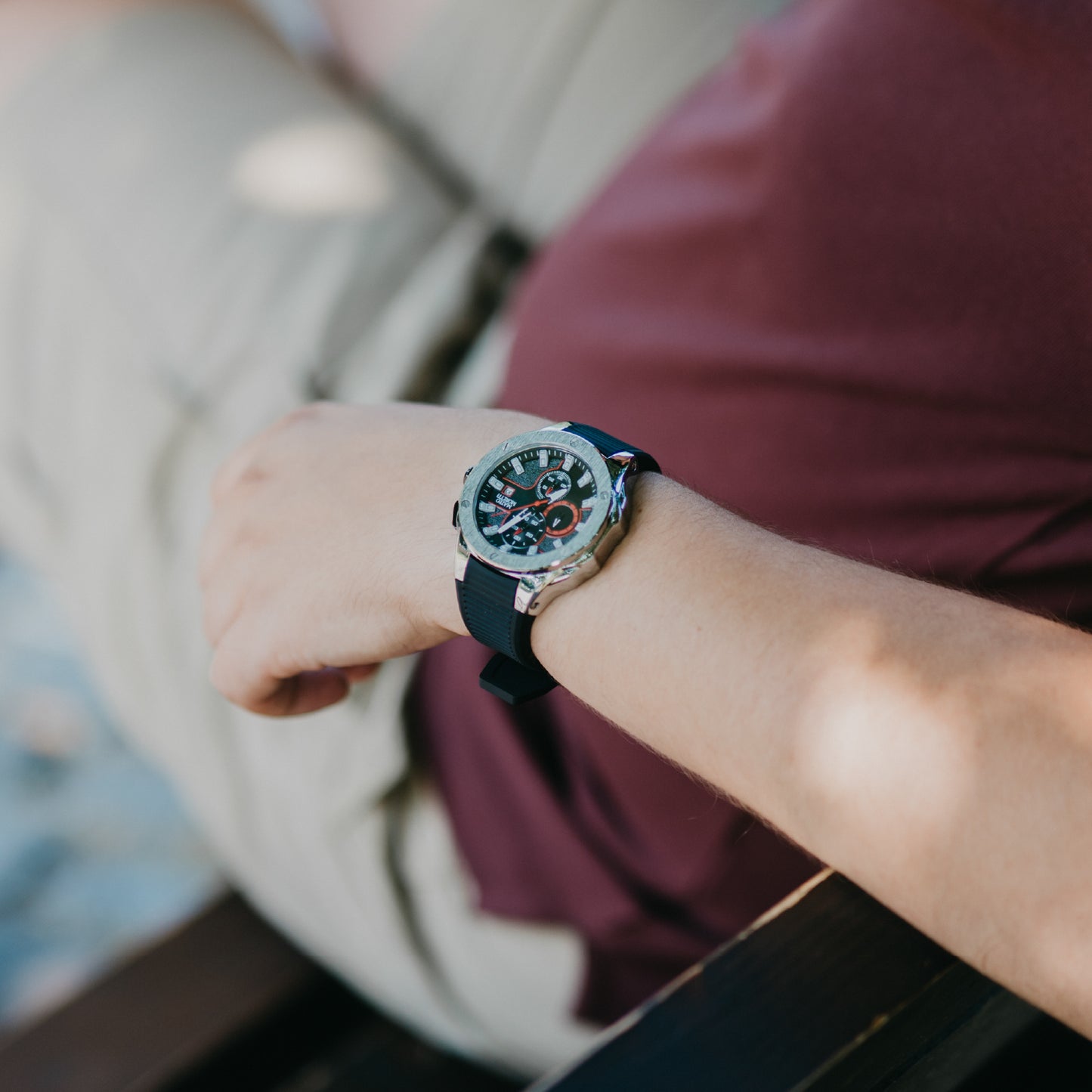 Lifestyle wrist shot of Mateo Moretti Sillaro Argento luxury chronograph watch with silver case, black strap, and red-accent dial