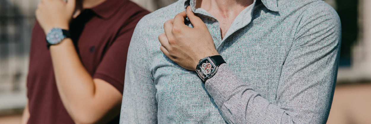 Two men wearing Mateo Moretti watches; foreground shows a skeleton tonneau watch on a black rubber strap